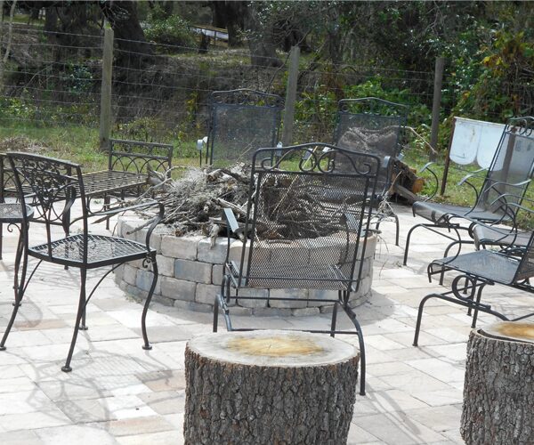 Metal chairs surrounding a fire pit